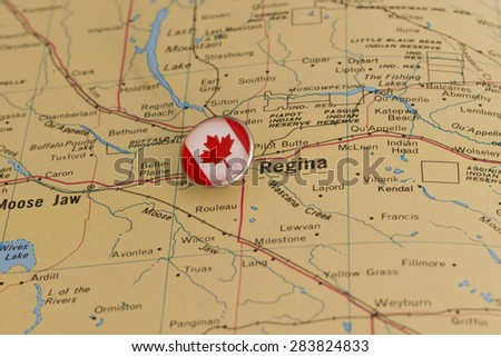 Regina marked with national flag pushpin on map. Selected focus on Regina and pushpin.