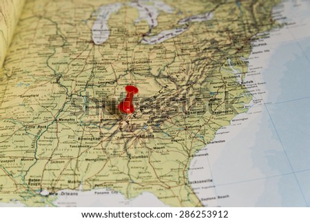 Chattanooga marked with red pushpin on map. Selected focus on Chattanooga and bright red pushpin. Pushpin is in an angle. Surrounding states and Nashville can also be seen.