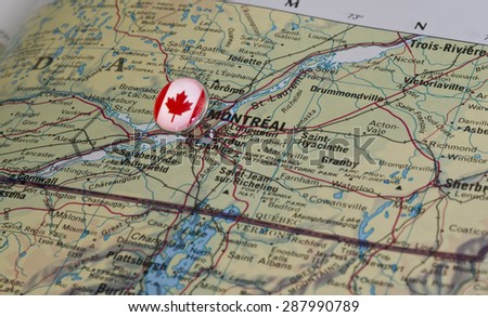 Montreal marked with national flag pushpin on map. Selected focus on Montreal and pushpin.