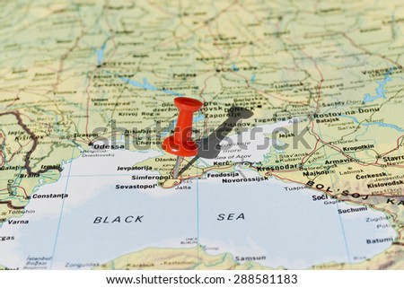 Simferopol in Ukraine marked with red pushpin on map. Selected focus on Simferopol and pushpin. Pushpin is in an angle and casts shadow to the right.