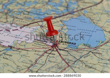Leningrad (currently known as Saint Petersburg) marked with red pushpin on old USSR map. Selected focus on Leningrad and pushpin.