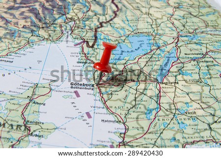 Goteborg marked with red pushpin on map. Selected focus on Goteborg and bright red pushpin. Pushpin is in an angle. Southern parts of Norway and Sweden can be seen on map.