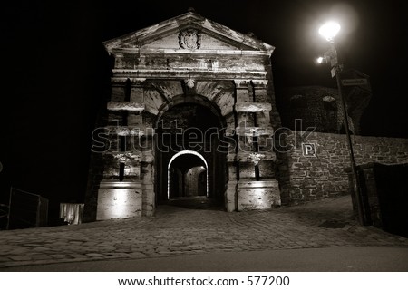 Entrance gate to the city castle in Altena, Germany, at night (location of the first youth hostel in the world). Quadtoned image, accentuating contrast brought out by lighting.