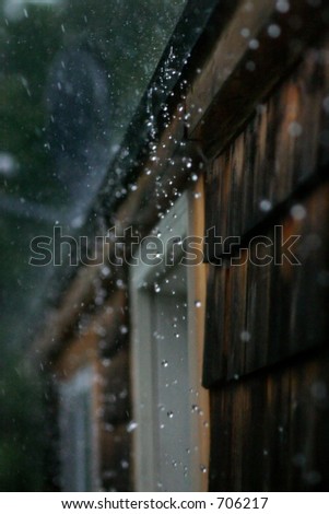 Rain hitting hard, splashing off a roof. High speed photography freezing droplets in mid air.