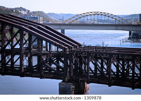 An old steel train bridge crossing a river. Taken in Pittsburgh, PA.