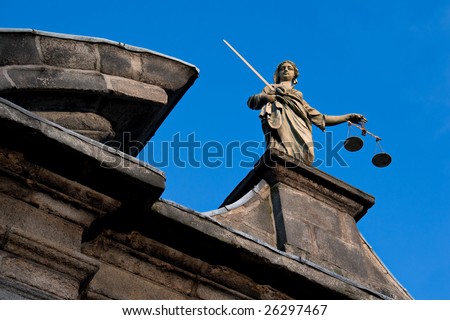 a statue of the goddess of justice atop a building
