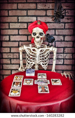 A skeleton doing a Tarot card reading.