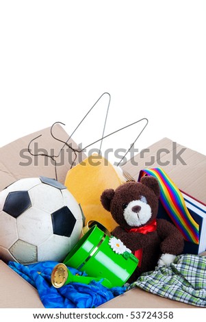 A box of unwanted stuff ready for a garage sale or to donate to a charitable organization.  Generic teddy bear.  Shot on white background.