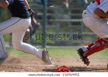 Baseball player getting to home plate with unknown results