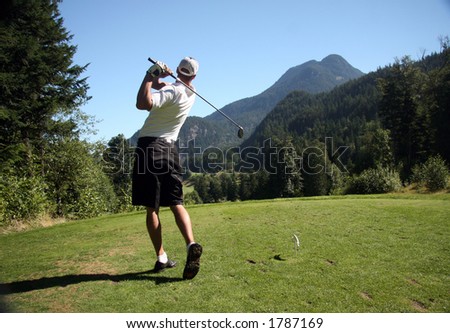 Golfer tees off on mountain course