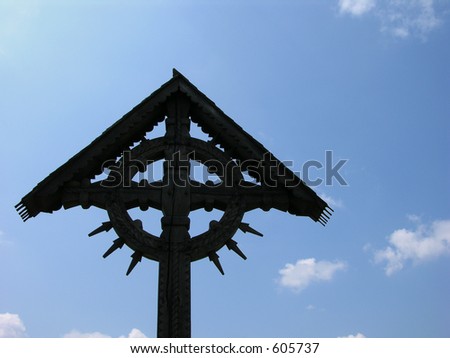 Black Cross Made From Abanos On A Blue Sky