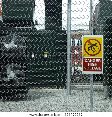Danger high voltage sign on a fence