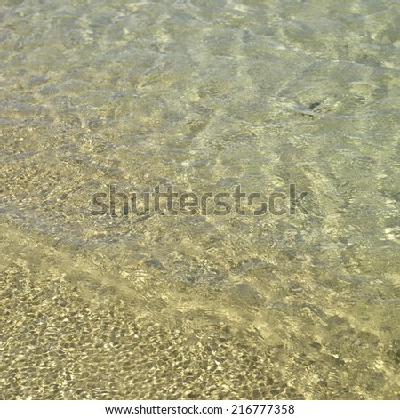Clear ocean water on gold sand