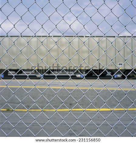 Looking at a train car through a chain link fence