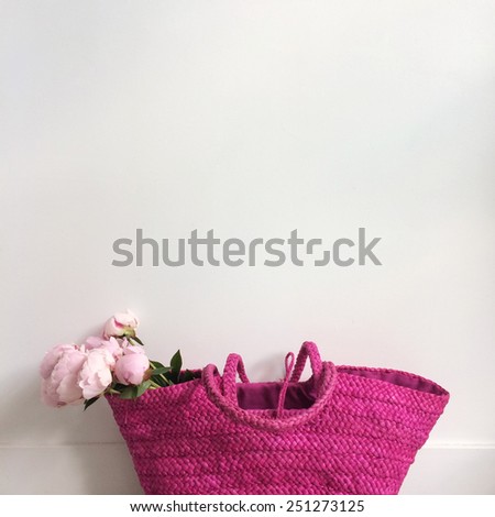 Bouquet of pink peonies in a bright pink bag
