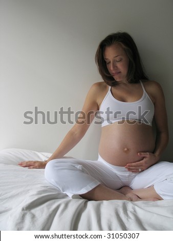 pregnant woman in white yoga clothes