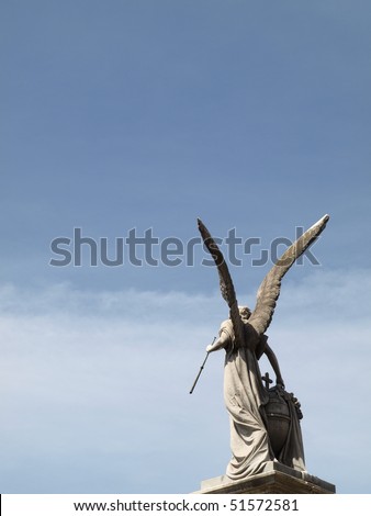 The back of angel with wings under blue sky from Recoleta Cemetery Argentina