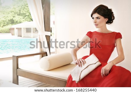Woman Relaxing Near Pool, Waiting On A Date, Dressed In Red, Elegant, Silk Dress.