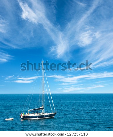 Luxury yatch in open waters with beautiful clouds