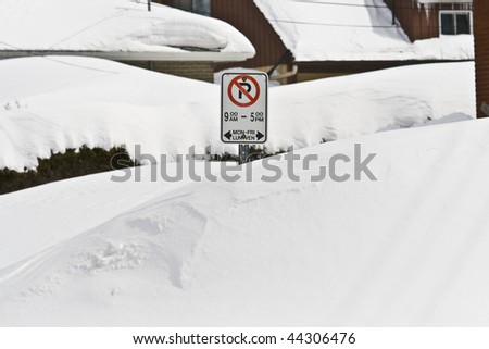 MARCH 9 2008: Snow drifts as high as the street side parking signs after a heavy snow storm in Ottawa Ontario Canada.