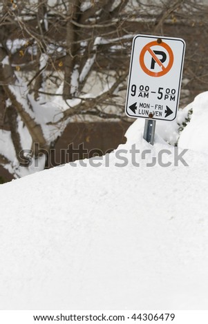 MARCH 9 2008: Snow drifts as high as the street side parking signs after a heavy snow storm in Ottawa Ontario Canada.