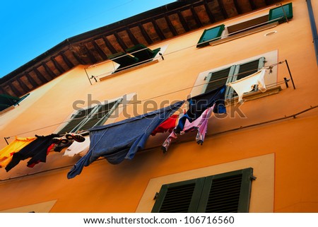 Clothes are drying on the rope against the window
