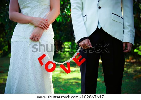 Just married couple holding a 
