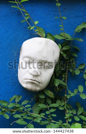 White face mask on a wall.