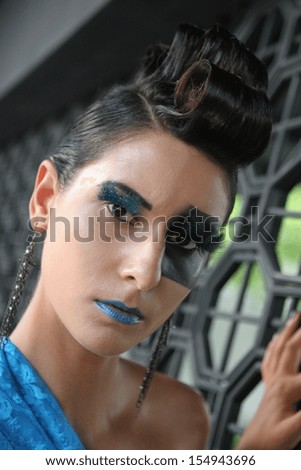Fashion image with bold make-up and modern hairstyle.