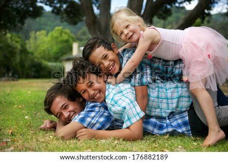 Happy group of four young children.