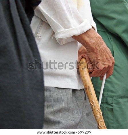 Old man holding onto his walking stick