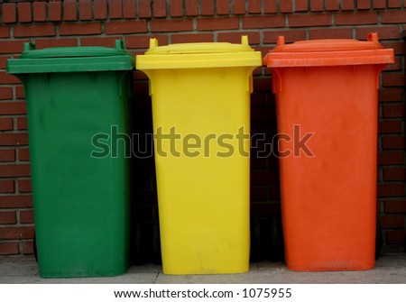 Green, yellow and orange rubbish bins in a row