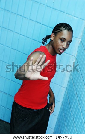 Jamaican man with his hand out in a defensive gesture