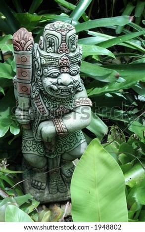 Warrior statue in tropical garden