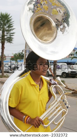 Young Thai girl in a marching band in a parade, Phuket, Thailand