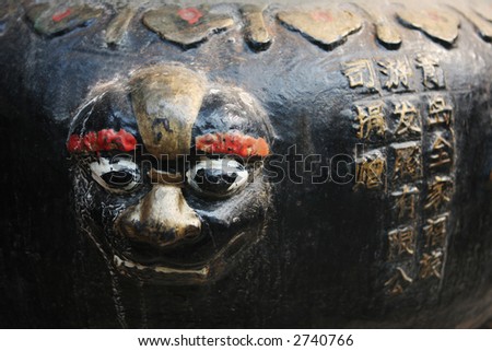 Close-up of a face sculpture at a temple in China - travel and tourism