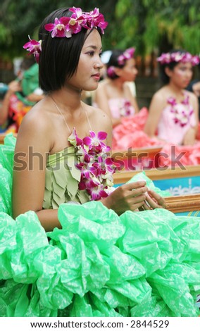 Beautiful Thai girl with orchids in her hair during in a parade, Phuket, Thailand - EDITORIAL