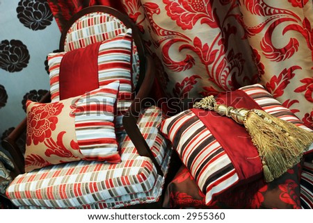 Luxurious red chair with satin pillows - home interiors