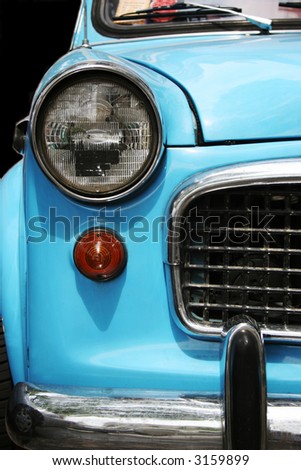 Close-up of the front of an old blue car
