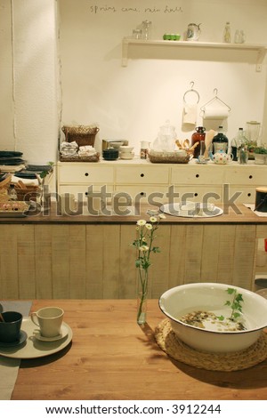 Pretty kitchen home interior with flowers on the bench.