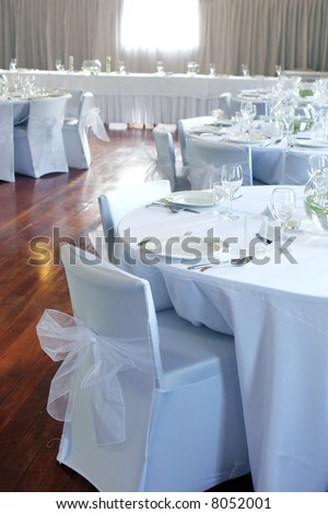 Tables decorated at a wedding reception.