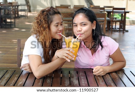 Pretty Asian girls having a drink at a cafe.
