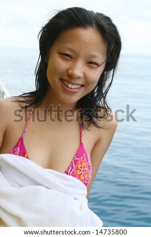 Pretty Asian woman on a boat trip.