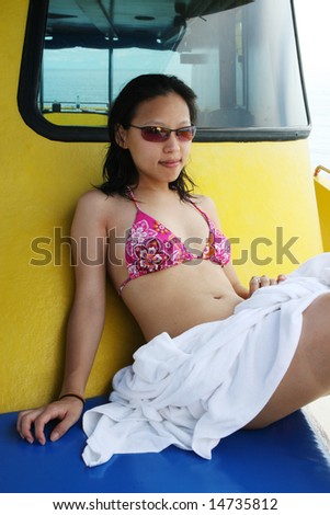 Pretty Asian woman on a boat trip.