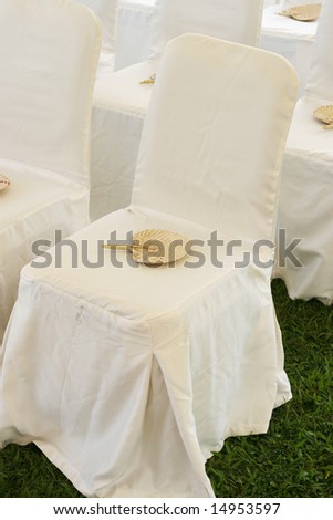 Chair with a fan at a wedding ceremony.