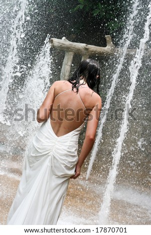 Bride walking into a fountain.