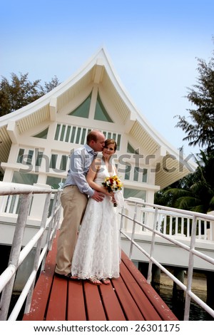 Happy bride and groom outside a wedding chapel.