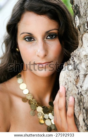 Portrait of a beautiful brunette woman in a leopard print dress.
