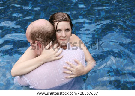 Gorgeous bride and groom in the water during a trash the dress photo shoot.