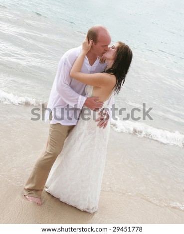 Gorgeous bride and groom on the beach - tropical destination wedding.